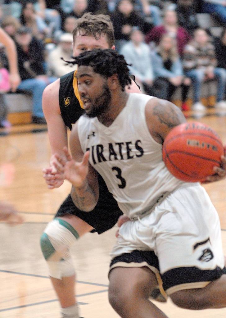 Peninsulas Davien Harris-Williams, front, shoulders past Shorelines David Perkins during Wednesday nights game at Peninsula College in Port Angeles. (Keith Thorpe/Peninsula Daily News)