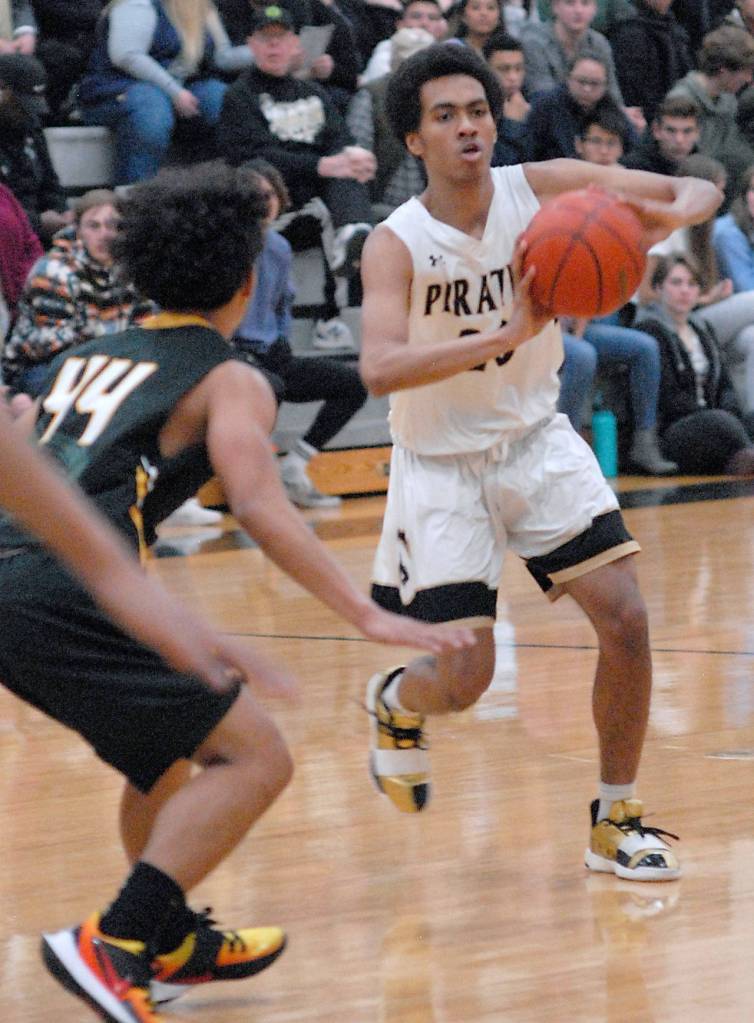 Peninsulas Ty Artis, right, looks to pass as Shorelines Jassem Cumlat defends on Wednesday night in Port Angeles. (Keith Thorpe/Peninsula Daily News)