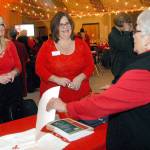 Sherry Phillips of Sequim, right, speaks with Amy McDonald of Crestwood Health and Rehabilitation of Port Angeles, left, and Cindy Kazlauskas of Sequim Health and Rehabilitation during Fridays 13th annual Red! Set! Go! Heart Luncheon at Vern Burton Community Center in Port Angeles. (Keith Thorpe/Peninsula Daily News)
