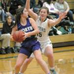 North Kitsaps Elizabeth Kimmel, left, looks to pass while defended by Port Angeles Myra Walker in Port Angeles in January. The Port Angeles girls begin play in the state 2A basketball tournament today. (Keith Thorpe/Peninsula Daily News)