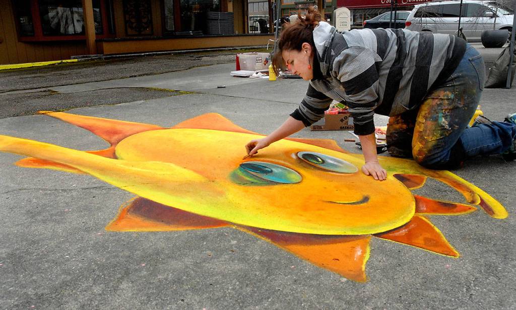 West Seattle chalk artist Naomi Haverland creates a 3D chalk drawing that changes shape based upon perspective at Centennial Place in downtown Sequim on Saturday during the weekends Sequim Sunshine Festival. (Keith Thorpe/Peninsula Daily News)