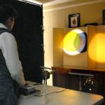 Cynthia Green of Sequim experiments with blends of light and shadows Saturday as part of an Interactive Light Experience at Sequims Pioneer Memorial Park. (Keith Thorpe/Peninsula Daily News)