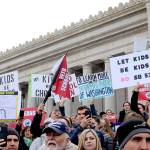 Protestors hold signs advocating a veto on Senate Bill 5395. (Cameron Sheppard/WNPA News Service)