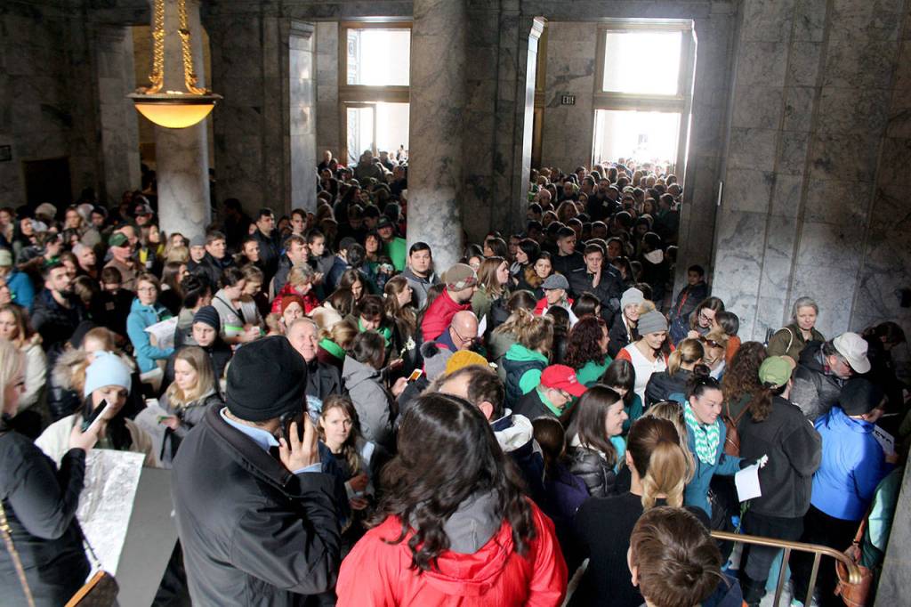 Protestors crowd the hallways as they line up to leave written comments of dissatisfaction in the governors office. (Cameron Sheppard/WNPA News Service)
