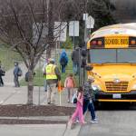 Children board buses at the end of the school day on Friday at Jefferson School in Port Angeles. The students will be on a six-week break beginning Tuesday following a decision made by Gov. Jay Inslee. (Keith Thorpe/Peninsula Daily News)