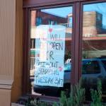 Open For Take Out: In an effort to keep business going, several restaurants, cafes and eateries are posting signs like these and are limiting their operating hours or only opening for take out order. (Ken Park/Peninsula Daily News)