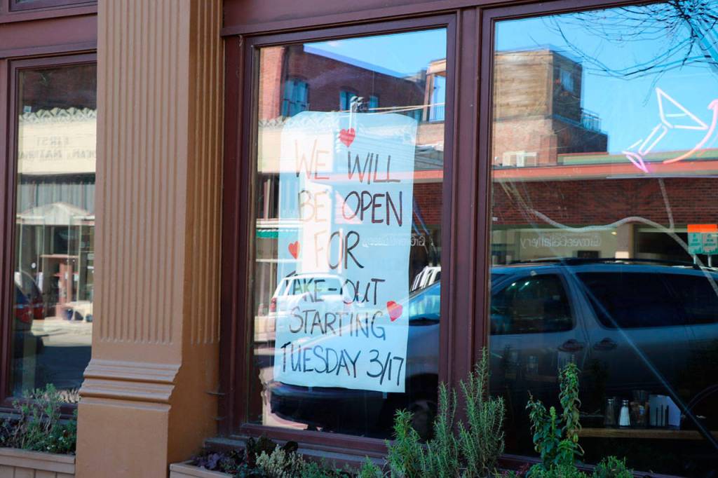 Open For Take Out: In an effort to keep business going, several restaurants, cafes and eateries are posting signs like these and are limiting their operating hours or only opening for take out order. (Ken Park/Peninsula Daily News)