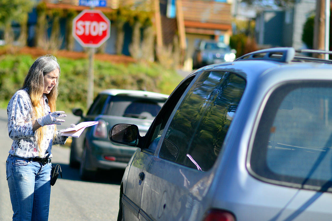 Port Townsend Food Bank manager Shirley Moss provides curbside service Wednesday, March 18, 2020. The food pantry will open for its weekly seniors day Saturday, March 21, 2020. (Diane Urbani de la Paz/for Peninsula Daily News)