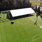 In this aerial drone photo, workers erect a temporary field hospital for use by people unable to isolate and recover from COVID-19 in their own homes on a soccer field Thursday, March 19, 2020, in the Seattle suburb of Shoreline. The field hospital will provide up to 200 beds, according to a city website, and will house people exposed to, at risk of exposure, or becoming ill with the novel coronavirus. (Elaine Thompson/The Associated Press)