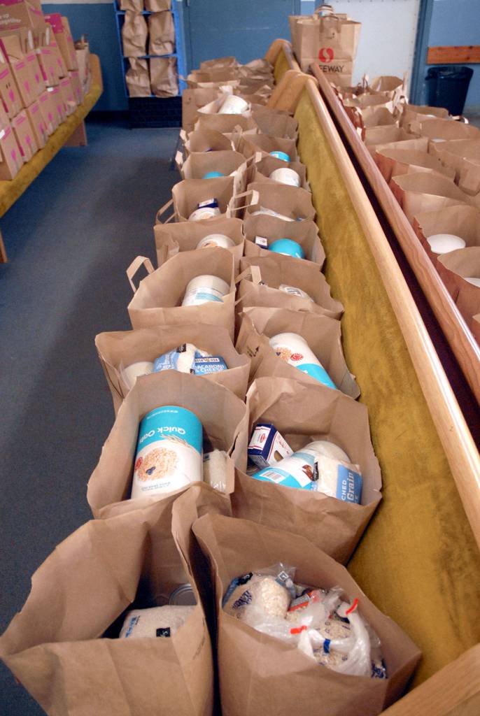Sacks filled with food and commodities await distribution at the Port Angeles Food Bank. (Keith Thorpe/Peninsula Daily News)