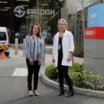 In this Tuesday, March 24, 2020, photo, Melissa Short, left, system executive director for womens health at Swedish Medical Center, and Dr. Tanya Sorensen, a practicing maternal fetal medicine physician at Swedish, and executive director for womens services, pose in front of the center in Edmonds, north of Seattle. Several dozen expectant moms who had planned to give birth at the birth unit of the center will now have to go elsewhere because the facility is being repurposed to treat victims of the new coronavirus. (Ted S. Warren/The Associated Press)