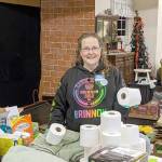 Brinnon Food Bank volunteer Kate Sullivan manages the non-food items that are donated, and she assists with preparing the boxes of food that are handed out to people in cars. (Zach Jablonski/Peninsula Daily News)