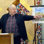 Richard Doc Robinson, executive director of Serenity House of Clallam County, points to an artists rendering of the Bridges Grill and a nearby laundromat on Eighth Street in Port Angeles that were under consideration for purchase by his agency to provide services for homeless young adults in this Dec. 15, 2018, file photo. Robinson has left his post at Serenity House. (Keith Thorpe/Peninsula Daily News file)