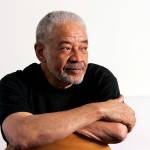 In this June 21, 2006, file photo, singer-songwriter Bill Withers poses in his office in Beverly Hills, Calif. Withers, who wrote and sang a string of soulful songs in the 1970s that have stood the test of time, including Lean On Me, Lovely Day and Aint No Sunshine, died in Los Angeles from heart complications Monday, March 30, 2020. He was 81. (Reed Saxon/Associated Press file)