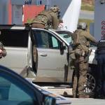 Royal Canadian Mounted Police officers surround a suspect at a gas station in Enfield, Nova Scotia, on Sunday April 19, 2020. Canadian police say multiple people are dead plus the suspect after a shooting rampage across the province of Nova Scotia. It was the deadliest shooting in Canada in 30 years. (Tim Krochak/The Canadian Press via AP)