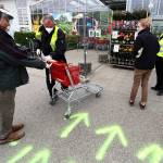 Security employee disinfect shopping carts at the entrance of a garden store in Munich, Germany, on Monday, April 20, 2020. Europes biggest economy, starts reopening some of its stores and factories after weeks of lockdown due to the new coronavirus outbreak. (Matthias Schrader/The Associated Press)