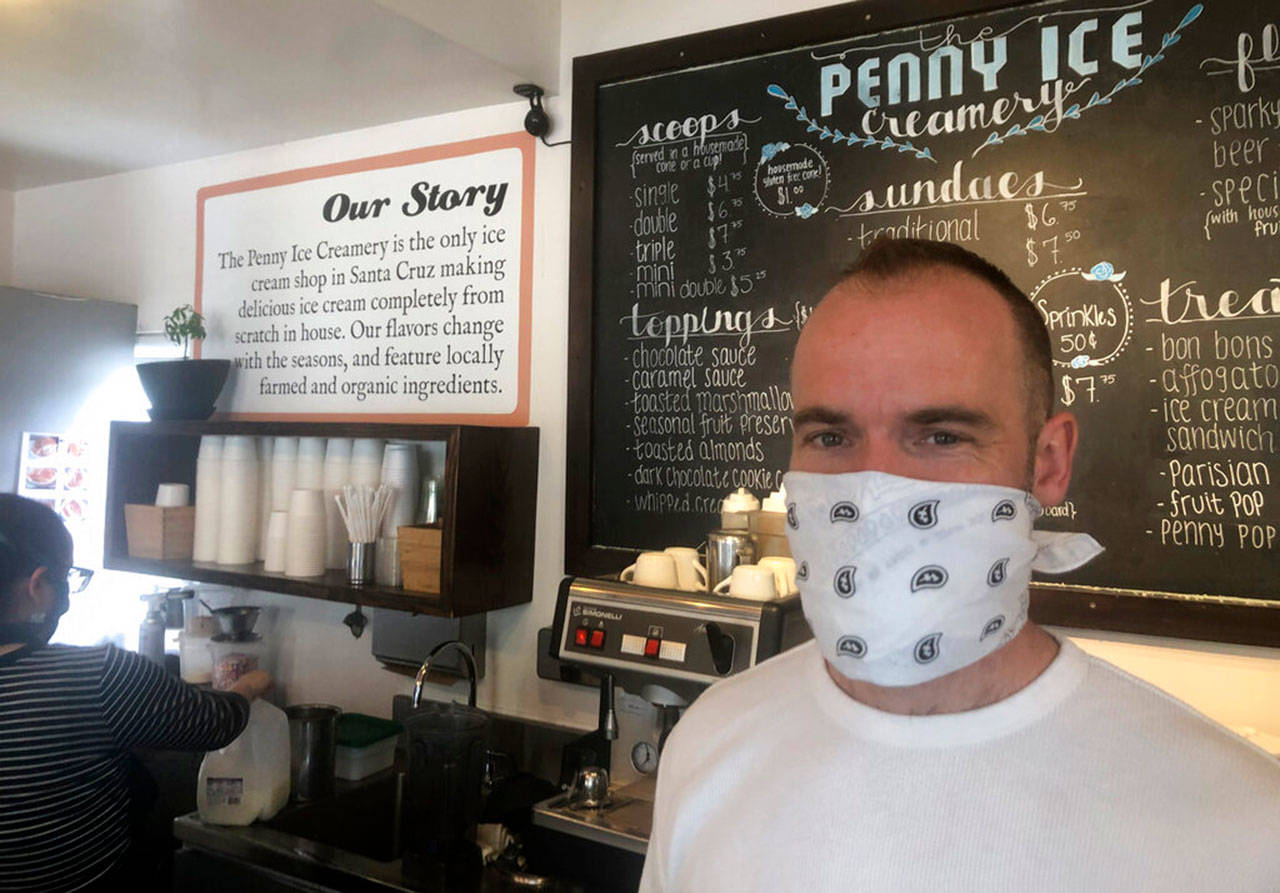 In this April 17, 2020, photo, Zachary Davis poses for a photo at The Penny Ice Creamery in Santa Cruz, Calif. An investigation by The Associated Press hows that many large companies which collectively received tens of millions of dollars in federal loans through the Paycheck Protection Program were at risk of failing even before the coronavirus walloped the economy, while others have acknowledged problems keeping their finances straight and a few have been under investigation by the Securities and Exchange Commission. That big companies and ones with questionable records received such precious financial aid during the chaotic last few weeks frustrates Davis, We were feeling pretty good about where we were in the world. Now its just all turned upside down, said Davis, who had to lay off 70 workers. (Martha Mendoza/Associated Press)