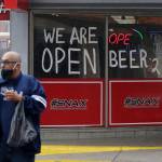 A man wears a face mask as he leaves a business that remains open in downtown San Antonio on Wednesday, April 22, 2020. San Antonio remains under stay-at-home orders due to the COVID-19 outbreak and residents are required to wear face coverings or masks whenever in public. (Eric Gay/Associated Press)