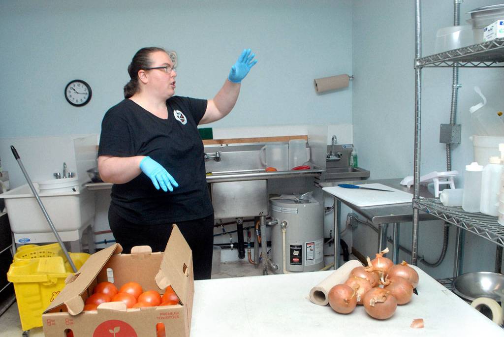 Shannon Reynolds talks about potential additons to the Corner Caboose storage building, including convection ovens and other equimpment to expand the menu. (Keith Thorpe/Peninsula Daily News)