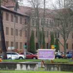 In this April 22, 2020, photo, a sign at Western State Hospital in Lakewood, Wash., directs visitors and non-hospital employees to check in at another building where health screening is done. Employees at the facility  the states largest psychiatric hospital  say that problems with testing for the coronavirus likely produced inaccurate results and exposed them to the virus a second time. (Ted S. Warren/Associated Press)