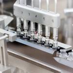 In this March 2020 photo provided by Gilead Sciences, rubber stoppers are placed onto filled vials of the investigational drug remdesivir at a Gilead manufacturing site in the United States. Given through an IV, the medication is designed to interfere with an enzyme that reproduces viral genetic material. (Gilead Sciences via The Associated Press)