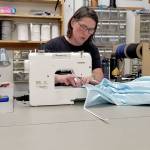 Daniele Johnson, canvas designer and seamstress for Sea Marine, works on sewing together a hospital gown that will go to Jefferson Healthcare. (Sea Marine)