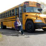 Sue Peterson, a bus driver with the Port Angeles School District, reads while waiting for students at a traveling wifi hot spot on Tuesday in the parking lot of the former Fairview School west of Port Angeles. (Keith Thorpe/Peninsula Daily News)