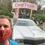 Danny Milholland, longtime organizer of the Cake Picnic, grins behind a face mask in front of the 78 Cadillac flatbed that will bring music to Port Townsend residents homes Saturday, May 16, 2020. Behind him, from left, are Kellen Lynch, Ben Krabil, Allison Barrett and Tomoki Sage. (Submitted photo)