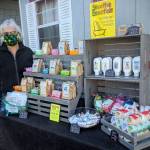 Sheila Gregg, owner of Smoothie Essentials Handmade Soaps, does a test run of her modified booth with essential product for opening day of the Sequim Farmers & Artisans Market, set for Saturday. (Emma Jane Garcia)