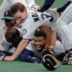 In this Oct. 8, 1995, file photo, Seattle Mariners Ken Griffey Jr. smiles from beneath a pile of teammates who mobbed him after he scored the winning run in the bottom of the 11th inning of a baseball game against the New York Yankees, in Seattle. The Seattle Mariners are the only baseball franchise never to advance to the Fall Classic. Baseball has never been played in Seattle beyond Oct. 22. The Mariners have three times been to the American League Championship Series, and all three times were sent home before there could ever be a Game 7. (Elaine Thompson/Associated Press file)