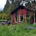 Assistant Fire Chief Tony Hudson with Clallam County Fire District 3 said firefighters responded twice to this Agnew-area house for fires. The second blaze engulfed the home. (Matthew Nash/Olympic Peninsula News Group)