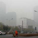 In this Nov. 14, 2018, file photo, a cleaner wearing a mask against pollution sweeps a street in Beijing. The world cut its daily carbon dioxide emissions by 17 percent at the peak of the pandemic shutdown last month, a new study found. But with life and heat-trapping gas levels inching back toward normal, the brief pollution break will likely be a drop in the ocean when it comes to climate change, scientists said. (Andy Wong/Associated Press file)