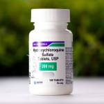 This Tuesday, April 7, 2020 file photo shows a bottle of hydroxychloroquine tablets in Texas City, Texas. The World Health Organization said Monday, May 25, 2020, that it will temporarily drop hydroxychloroquine from its global study into experimental COVID-19 treatments because its experts need to review all available evidence. (David J. Phillip/Associated Press file)