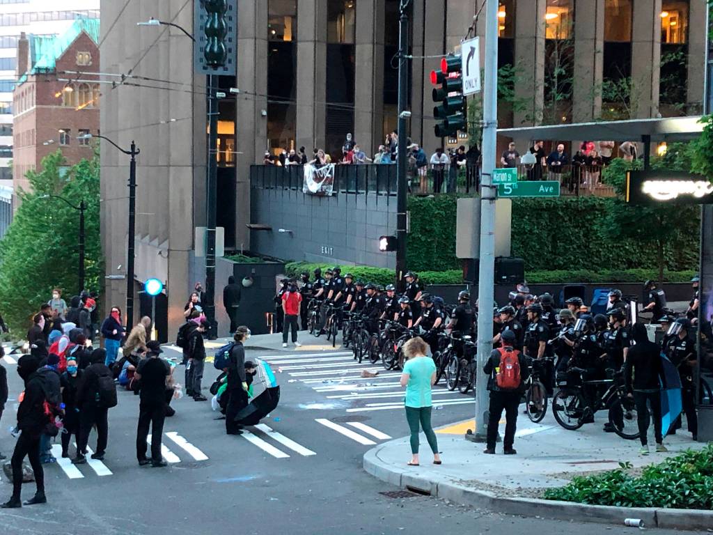 In this May 29, 2020, photo, demonstrators are shown at 5th Avenue and Marion Street in downtown Seattle during a march in solidarity with Minneapolis and protesting police brutality. Protests have been erupting all over the country after George Floyd died earlier this week in police custody in Minneapolis. (Amanda Snyder/The Seattle Times via AP)