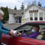 Loretta Bilow holds a practice run with Bonnie Hagberg for the Sequim Prairie Granges upcoming Drive-Up Ice Cream Social. (Matthew Nash/Olympic Peninsula News Group)
