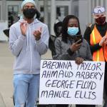 A protester holds a sign with the names of people who have died while in police custody, during police actions, or were victims of alleged racially motivated killings, Friday, June 5, 2020, in Tacoma, Wash., during a protest against police brutality and the death of George Floyd, a black man who died after being restrained by Minneapolis police officers on May 25. On Thursday, the mayor of Tacoma called for the firing of police officers involved in the death of Manuel Ellis, who died March 3 while being held down by Tacoma police, after the Pierce County medical examiners office determined that the restraint caused his death. (AP Photo/Ted S. Warren)