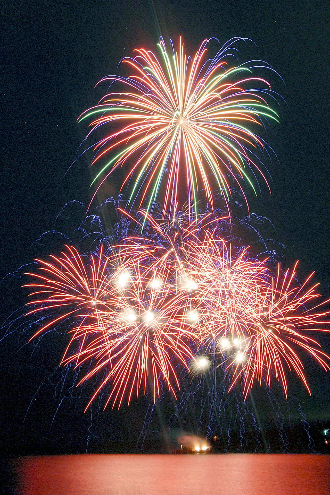 Bursts of fireworks light up the sky over Port Angeles Harbor during the 2019 Independence Day display. (Keith Thorpe/Peninsula Daily News file)