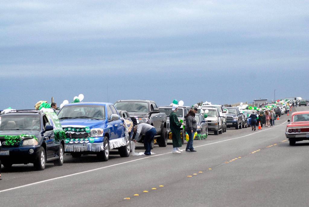 Decorated cars line up on Ediz Hook in Port Angeles on Friday prior to the start of a procession of Port Angeles High School graduates through the streets of the city. The motorcade was arranged to make up for the lack of an official graduation ceremony, which was canceled for fear of spreading COVID-19. (Keith Thorpe/Peninsula Daily News)