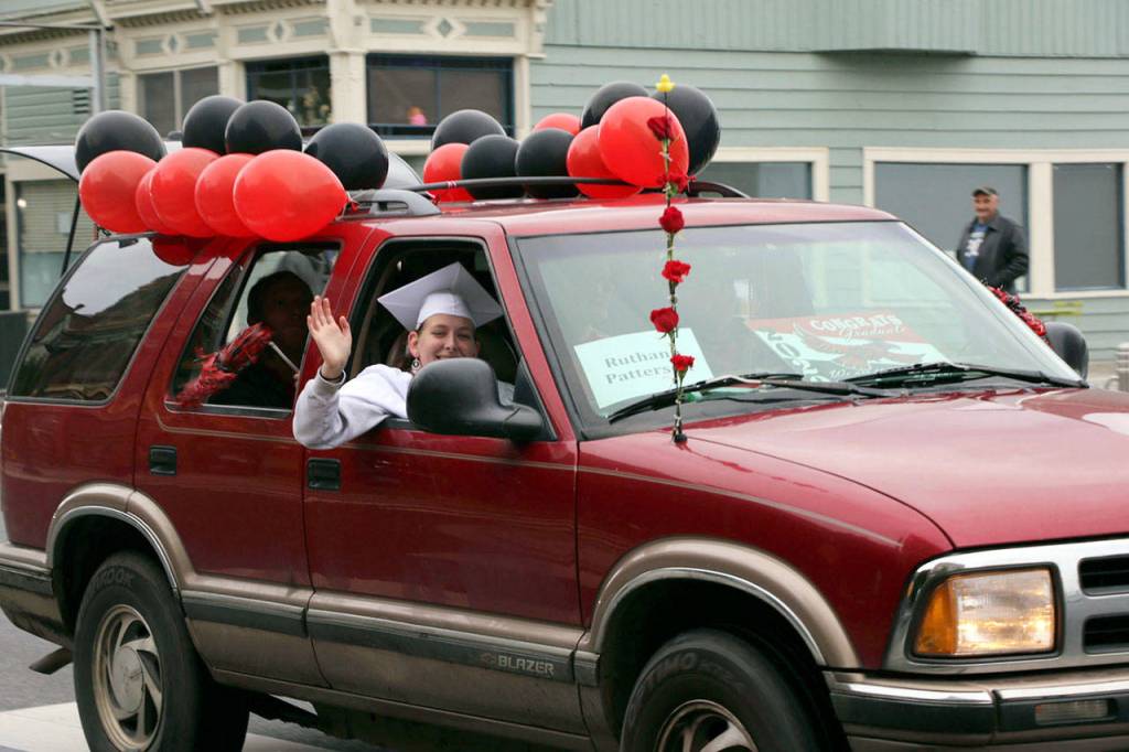 The Port Townsend High School Class of 2020 rolled down Water St. in vehicles as part of its modified graduation celebration Friday. (Ken Park/Peninsula Daily News)