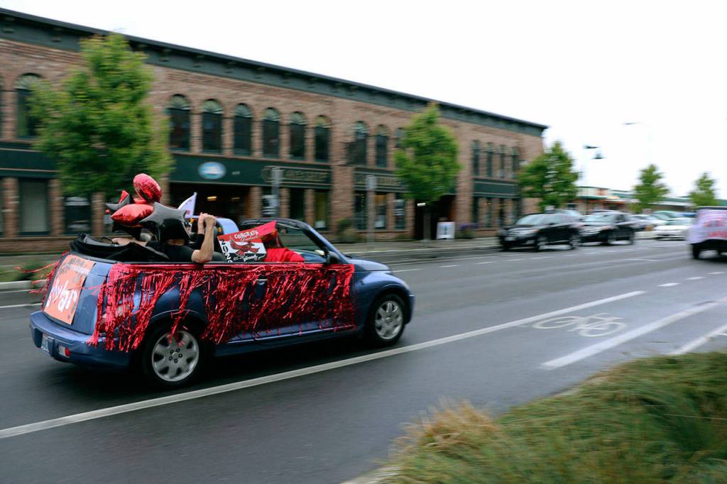 The Port Townsend High School Class of 2020 rolled down Water St. in vehicles as part of its modified graduation celebration Friday. (Ken Park/Peninsula Daily News)