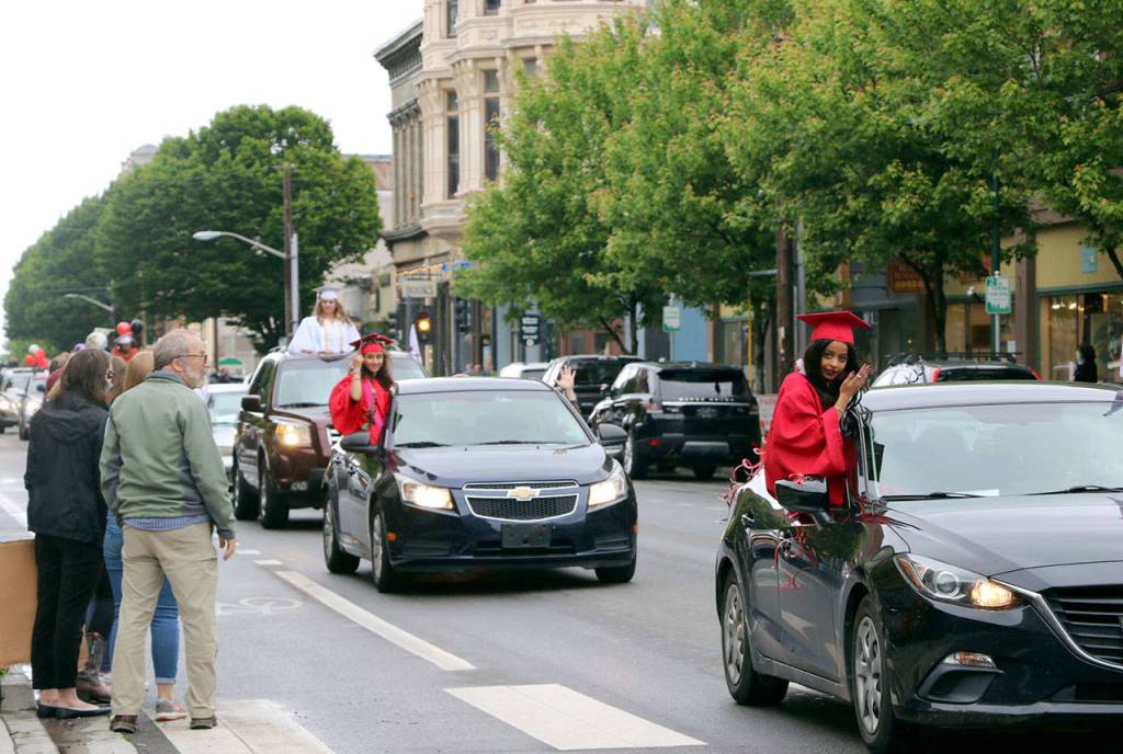 The Port Townsend High School Class of 2020 rolled down Water St. in vehicles as part of its modified graduation celebration Friday. (Ken Park/Peninsula Daily News)