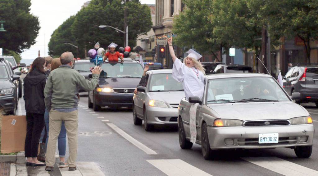 The Port Townsend High School Class of 2020 rolled down Water St. in vehicles as part of its modified graduation celebration Friday. (Ken Park/Peninsula Daily News)