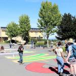 Ahead of todays Juneteenth celebration and march, members of the Jefferson County Chapter of Black Lives Matter and the City of Port Townsend Arts Commission paint a temporary art installation along the north end of Water Street on Thursday. The words Black Lives Matter are outlined and colored on the street. Juneteenth begins at 11 a.m. today at Pope Marine Park with speakers and music. A march is planned starting at 11:45 a.m. or noon to go the intersection of Haines Place and Sims Way. (Ken Park/Peninsula Daily News)