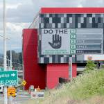 A large video display offers guidelines for reducing the risk of the spread of the coronavirus Thursday at the new Emerald Queen Casino, which is open, and owned by the Puyallup Tribe of Indians in Tacoma. The U.S. economy is stumbling as the viral outbreak intensifies, threatening to slow hiring and deepening the uncertainty for employees, consumers and companies across the country. (Ted S. Warren/The Associated Press)