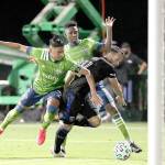Seattle Sounders defender Xavier Arreaga, left, and defender Kelvin Leerdam, center rear, prevent San Jose Earthquakes midfielder Vako from scoring during the second half of an MLS soccer match, Friday, July 10, 2020, in Kissimmee, Fla. (AP Photo/John Raoux)