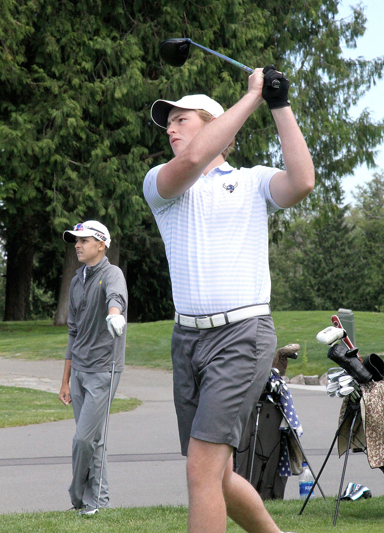 Western Washington Universitys Devin Andrews tees off at the first hole at Cedars at Dungeness on Sunday, July 12, 2020, in the Clallam County Amateur. Andrews won the event by two strokes, with second-place finisher Cole Reynolds of Auburn in the background. (Dave Logan/for Peninsula Daily News)