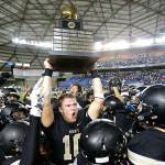 In this Dec. 3, 2016, file photo, Royal quarterback Kaden Jenks (10) celebrates with the trophy after Royal beat Connell in the Washington Div. 1A high school football championship in Tacoma, Wash. The overwhelming uncertainty of whether high school sports can go forward in the fall of 2020 amidst the continued COVID-19 pandemic is a constant refrain among administrators and decision makers as the clock ticks closer to the start of the 2020-21 school year with little clarity in place for an obvious and safe path moving forward for athletics. (Ted S. Warren/Associated Press file)