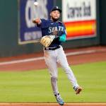 Seattle Mariners shortstop J.P. Crawford throws to first after fielding an infield hit by Houston Astros Jose Altuve during the fifth inning of a baseball game Friday, July 24, 2020, in Houston. The Astros Aledmys Diaz scored on Altuves single. (AP Photo/David J. Phillip)