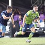 Seattle Sounders forward Jordan Morris, right, controls the ball in front of Vancouver Whitecaps defender Jake Nerwinski during the second half of an MLS soccer match, Sunday, July 19, 2020, in Kissimmee, Fla. (AP Photo/Phelan M. Ebenhack)