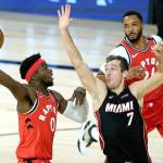 Toronto Raptors Terence Davis (0) shoots over Miami Heats Goran Dragic (7) during the first half of an NBA basketball game Monday, Aug. 3, 2020, in Lake Buena Vista, Fla. (AP Photo/Ashley Landis, Pool)